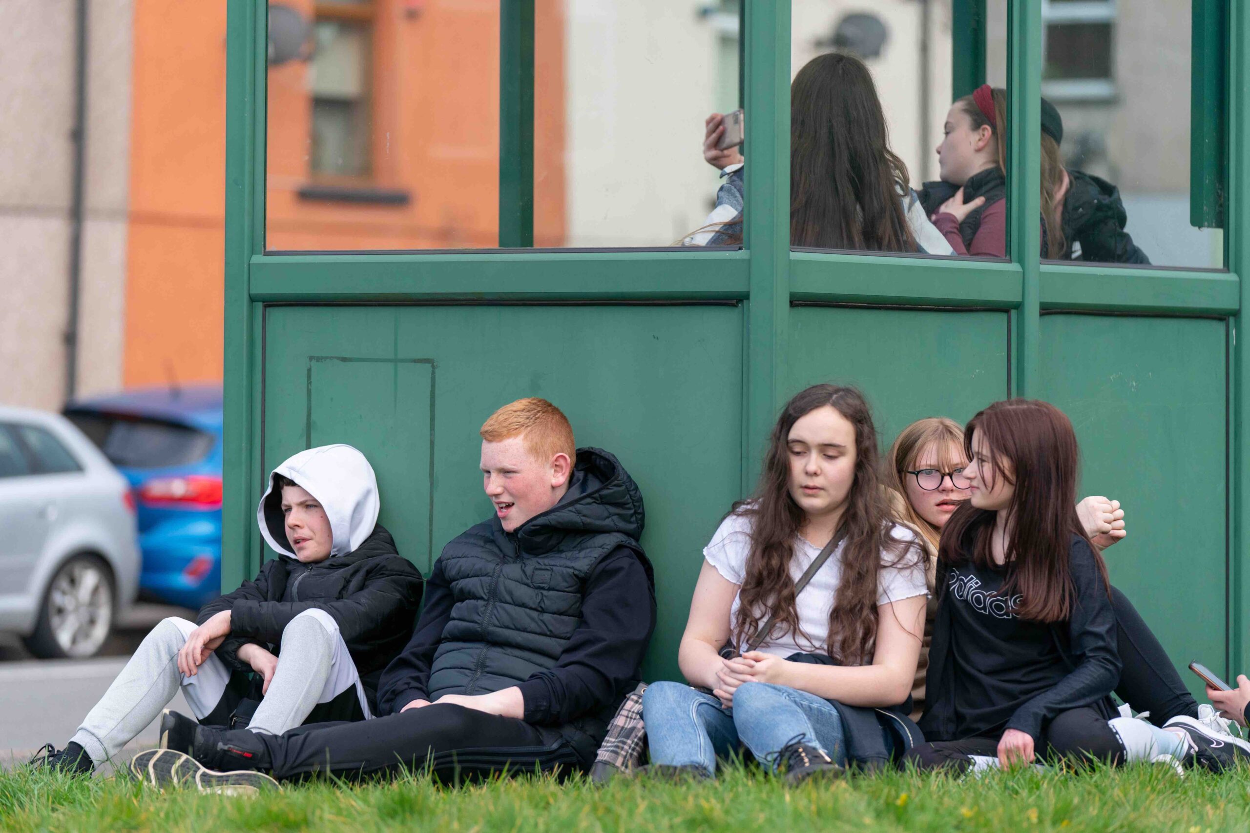 teens talking at bus stop