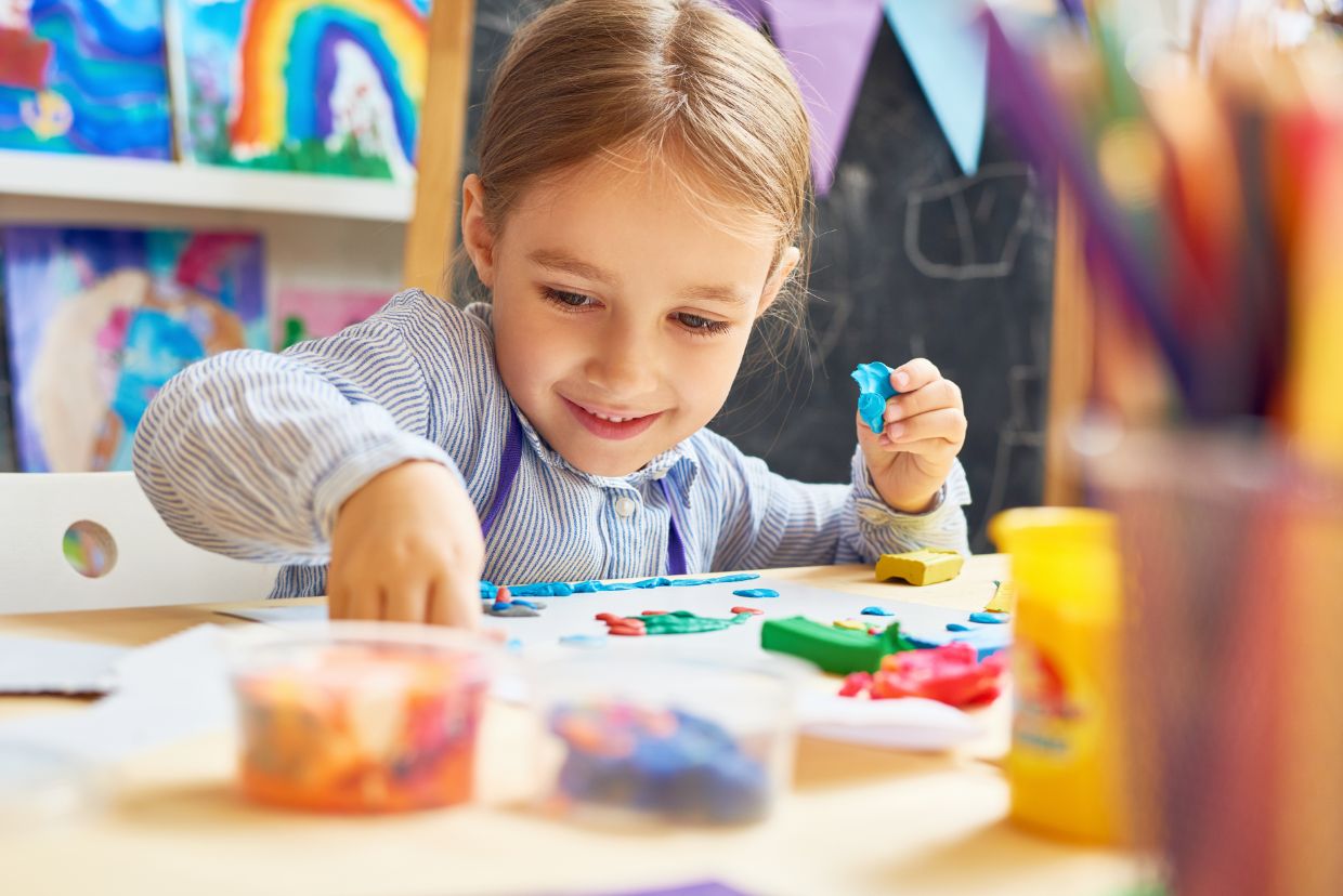 girl playing with playdough