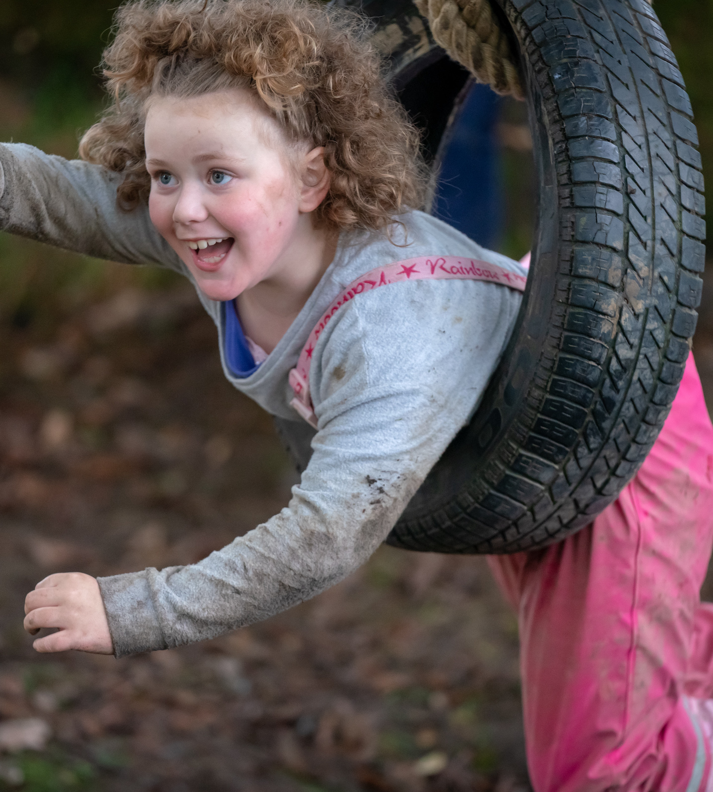 children playing in suspended tyre